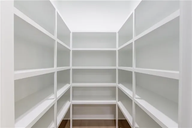a kitchen with windows and refrigerator
