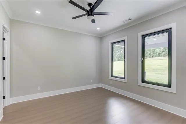 an empty room with closet and windows