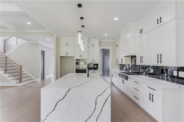 a kitchen with stainless steel appliances a sink stove and refrigerator