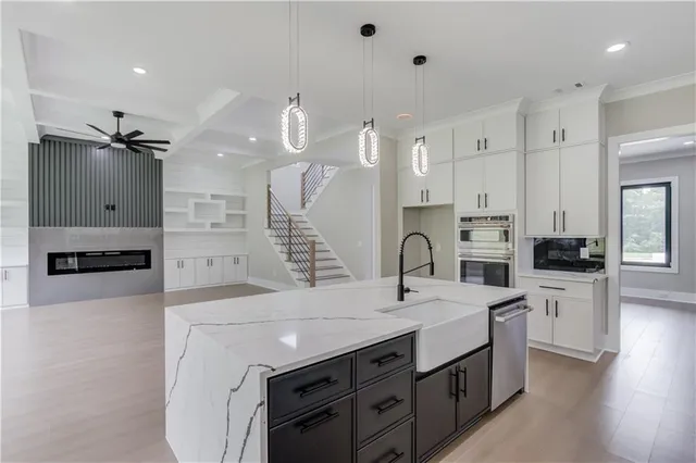 a large kitchen with a large counter top appliances and cabinets