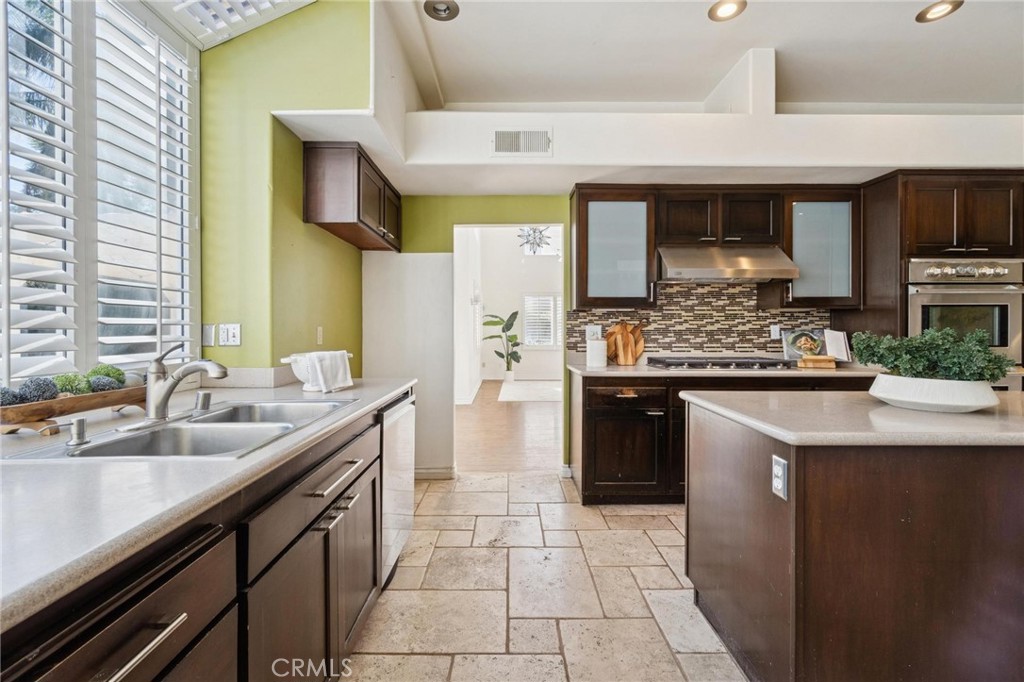 25528 Paine Circle Stevenson Ranch, CA 91381 - Photo 20 of 63 a kitchen with stainless steel appliances granite countertop a sink and cabinets