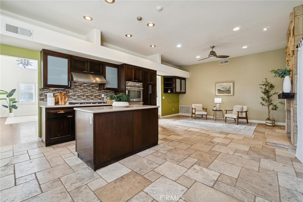 25528 Paine Circle Stevenson Ranch, CA 91381 - Photo 23 of 63 a large kitchen with stainless steel appliances kitchen island granite countertop a large counter top and stove