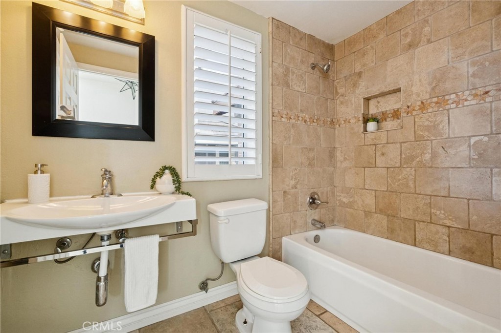 25528 Paine Circle Stevenson Ranch, CA 91381 - Photo 29 of 63 a bathroom with a granite countertop toilet a sink and a bathtub