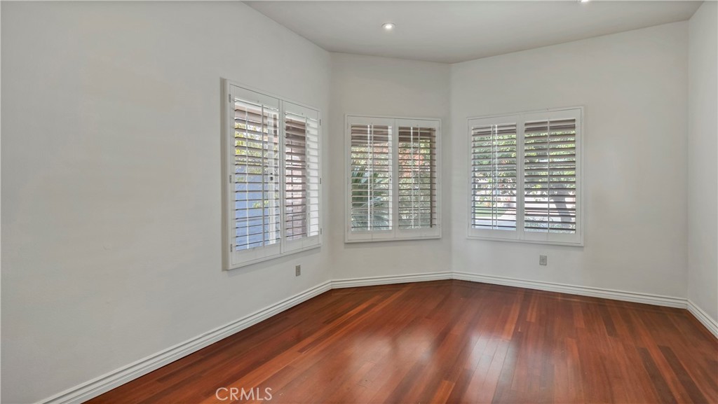 25528 Paine Circle Stevenson Ranch, CA 91381 - Photo 30 of 63 a view of an empty room with wooden floor and a window