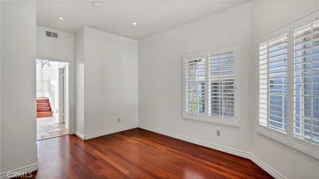 25528 Paine Circle Stevenson Ranch, CA 91381 - Photo 31 of 63 a view of an empty room with wooden floor and a window