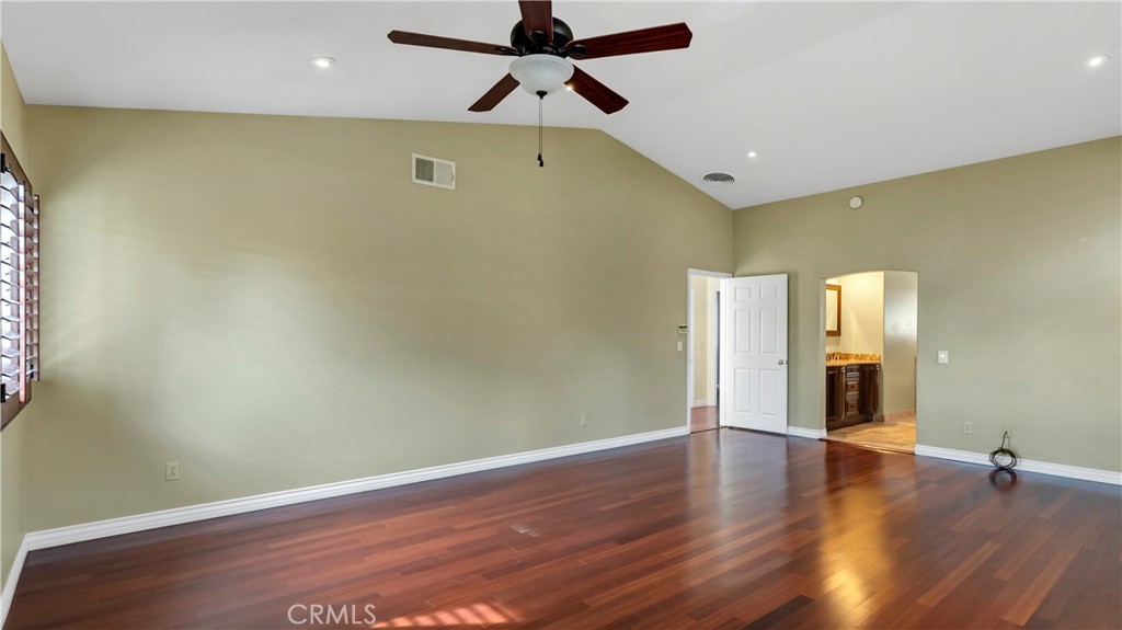 25528 Paine Circle Stevenson Ranch, CA 91381 - Photo 35 of 63 an empty room with wooden floor and windows