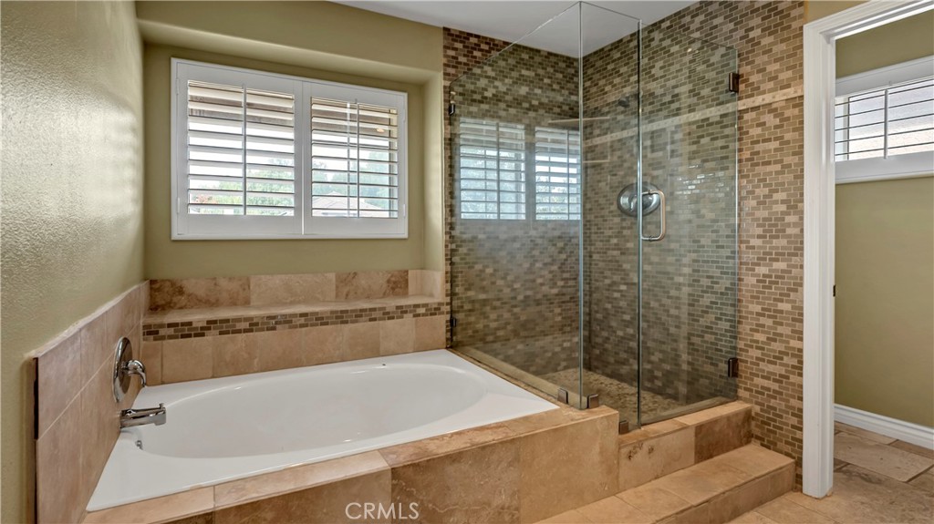 25528 Paine Circle Stevenson Ranch, CA 91381 - Photo 37 of 63 a bathroom with a bathtub and a shower