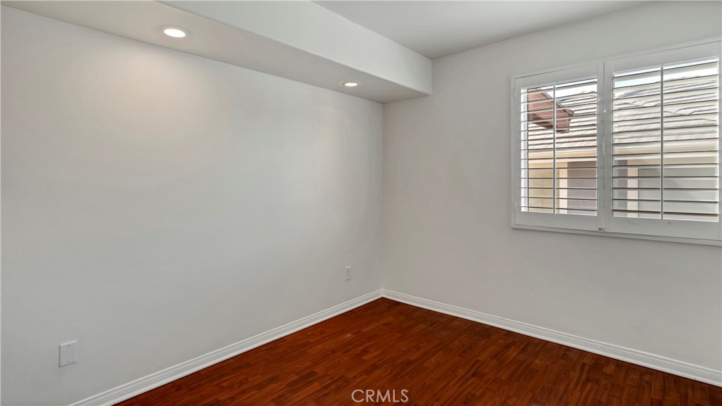 25528 Paine Circle Stevenson Ranch, CA 91381 - Photo 38 of 63 a view of an empty room with wooden floor and a window