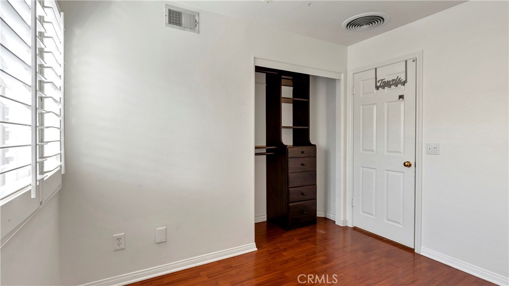 25528 Paine Circle Stevenson Ranch, CA 91381 - Photo 39 of 63 an empty room with wooden floor and windows