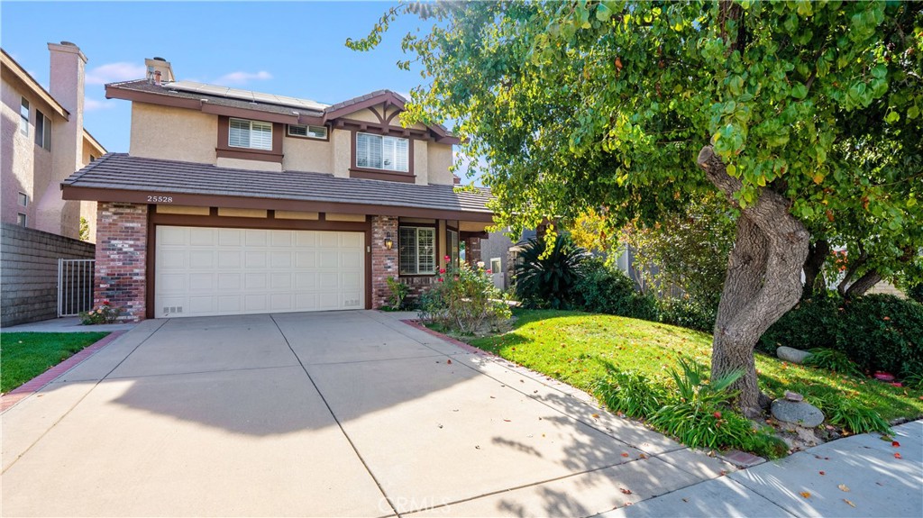 25528 Paine Circle Stevenson Ranch, CA 91381 - Photo 47 of 63 a front view of a house with a yard and garage
