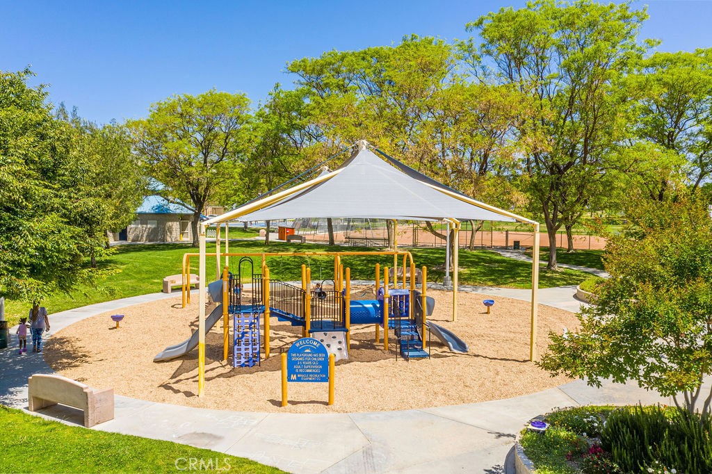 25528 Paine Circle Stevenson Ranch, CA 91381 - Photo 55 of 63 a view of a patio with a table and chairs under an umbrella
