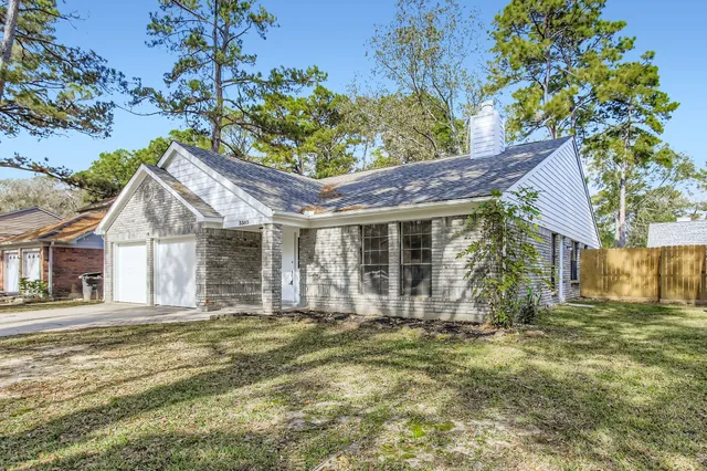 a view of a brick house with a large window