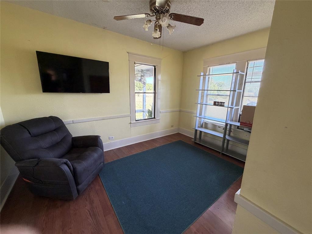 8041 Highway 11 Whitewright, TX 75491 - Photo 9 of 14 a living room with furniture and a flat screen tv