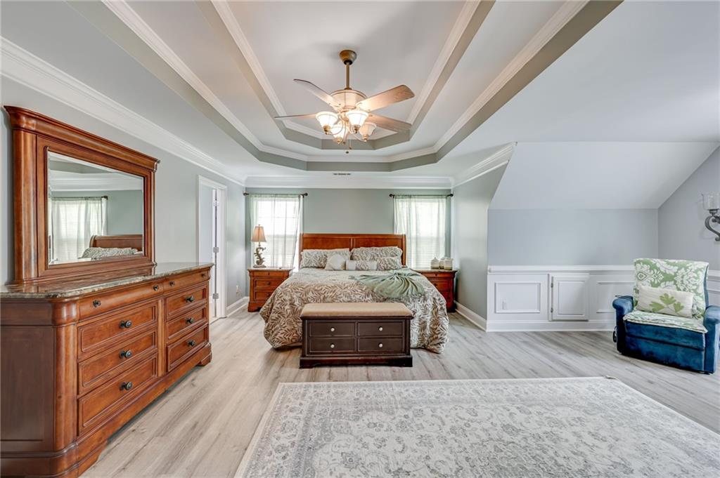 32 St Ives Circle Winder, GA 30680 - Photo 22 of 38 a bedroom with a large bed and a chandelier