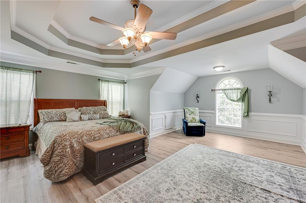 32 St Ives Circle Winder, GA 30680 - Photo 23 of 38 a spacious bedroom with a large bed and a chandelier