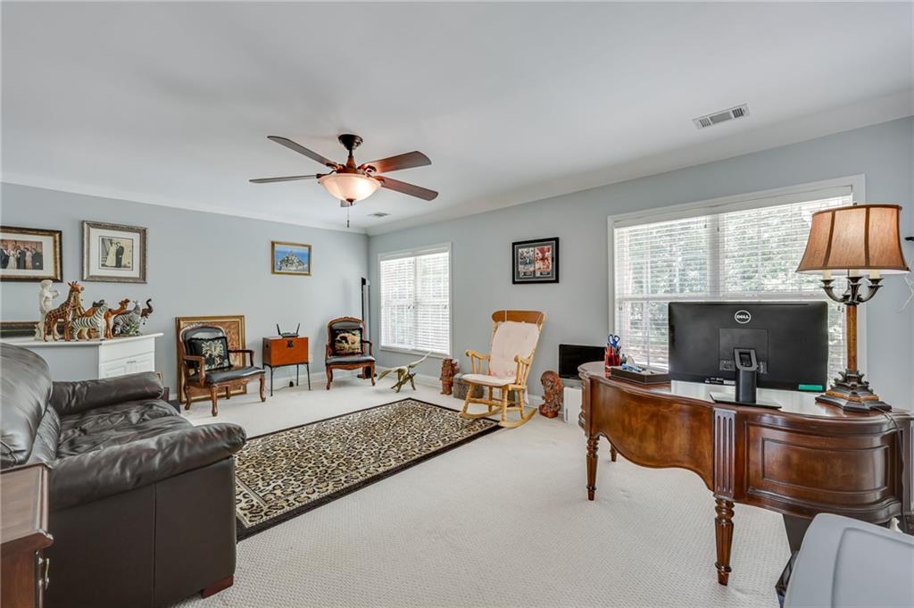 32 St Ives Circle Winder, GA 30680 - Photo 31 of 38 a living room with furniture and a flat screen tv