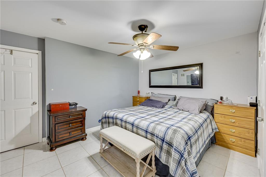 32 St Ives Circle Winder, GA 30680 - Photo 37 of 38 a bedroom with a bed and a chandelier