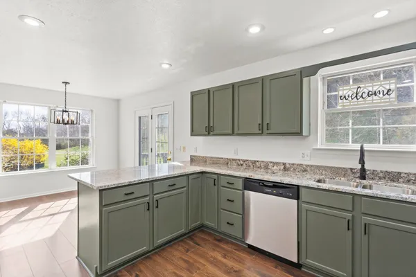 a kitchen with a sink cabinets and window