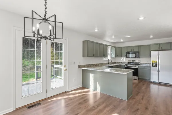 a kitchen with stainless steel appliances granite countertop a stove and a refrigerator