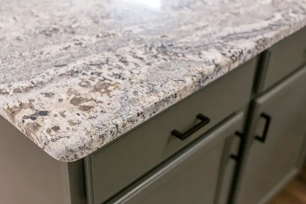 a kitchen with granite countertop a sink and a window
