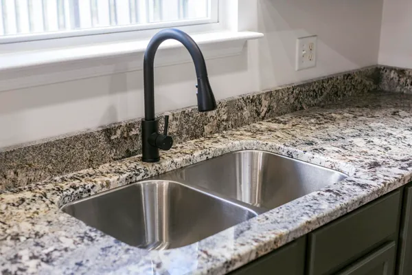 a kitchen with stainless steel appliances a sink stove and refrigerator