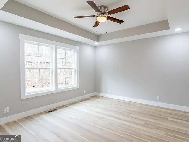 wooden floor in an empty room with a window