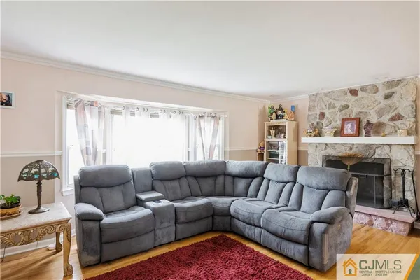 a living room with furniture a couch and a window