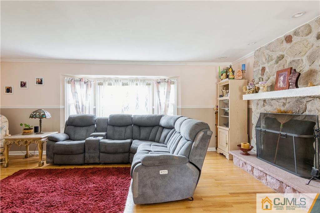 33 Dusko Drive Sayreville, NJ 08859 - Photo 14 of 30 a living room with furniture and a fireplace