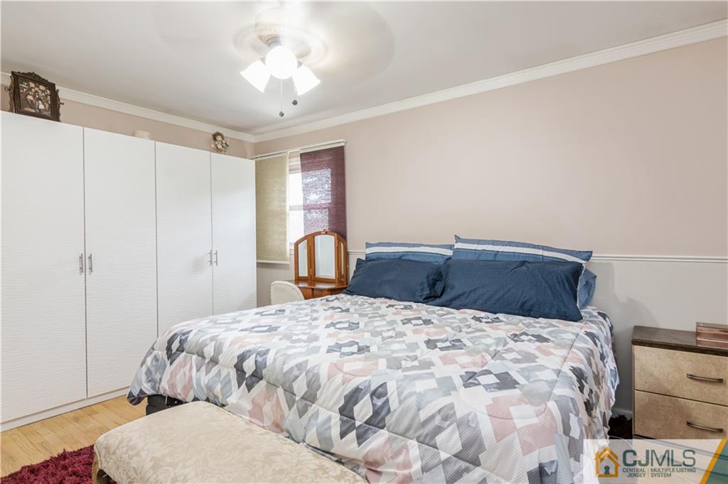 33 Dusko Drive Sayreville, NJ 08859 - Photo 21 of 30 a bedroom with a bed and a chandelier