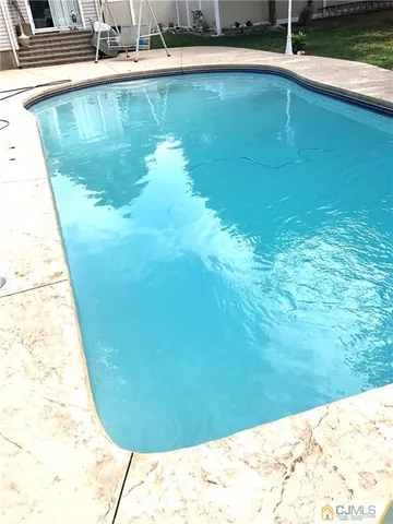 a view of a swimming pool with a yard