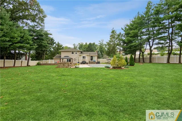 a view of house with backyard