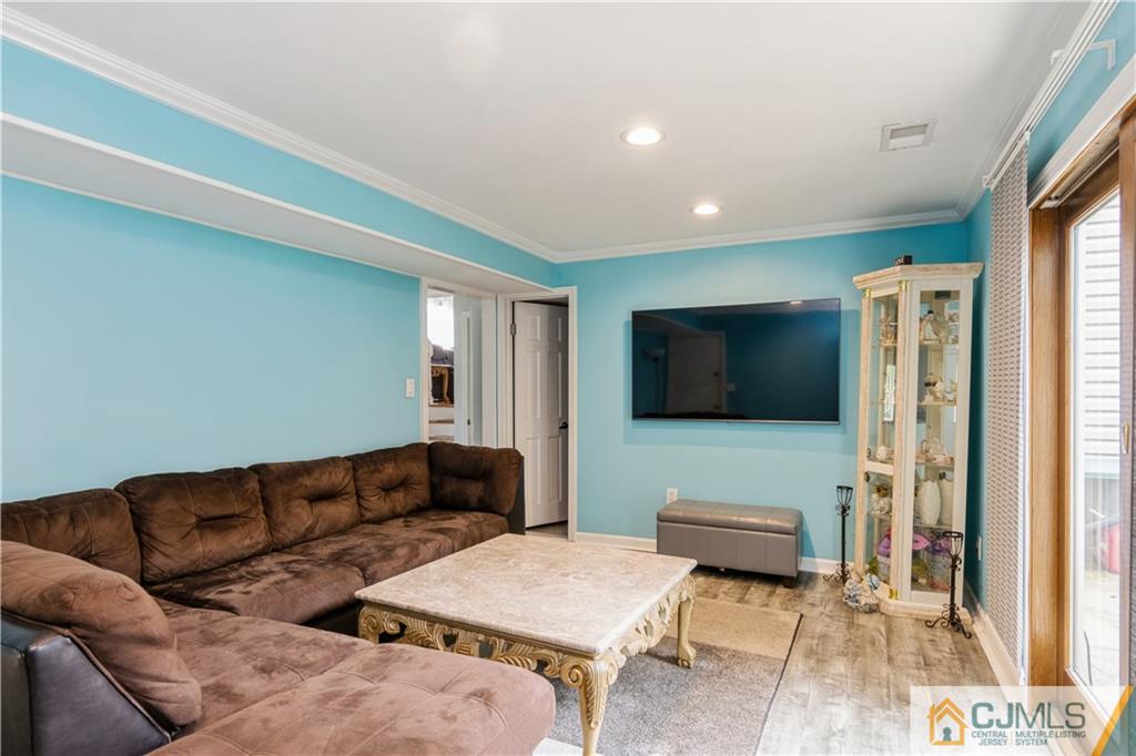 33 Dusko Drive Sayreville, NJ 08859 - Photo 4 of 30 a living room with furniture and a flat screen tv