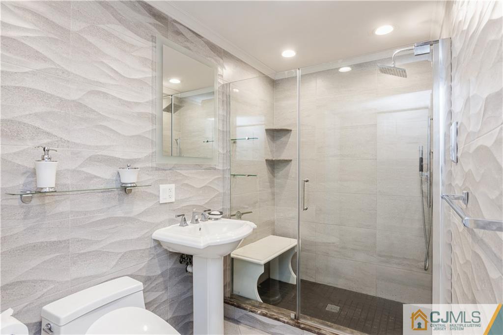 33 Dusko Drive Sayreville, NJ 08859 - Photo 6 of 30 a bathroom with a sink shower and a mirror