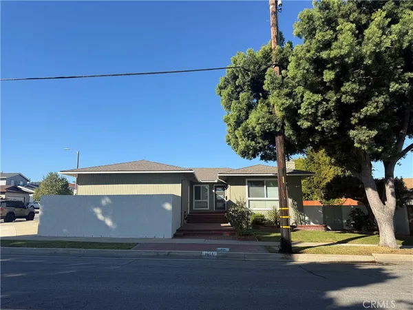 a view of a house with a tree and a yard