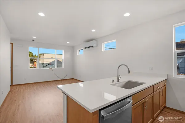 a kitchen with a sink cabinets and wooden floor