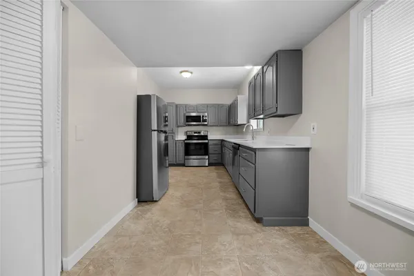 a kitchen with stainless steel appliances granite countertop a refrigerator and a stove top oven