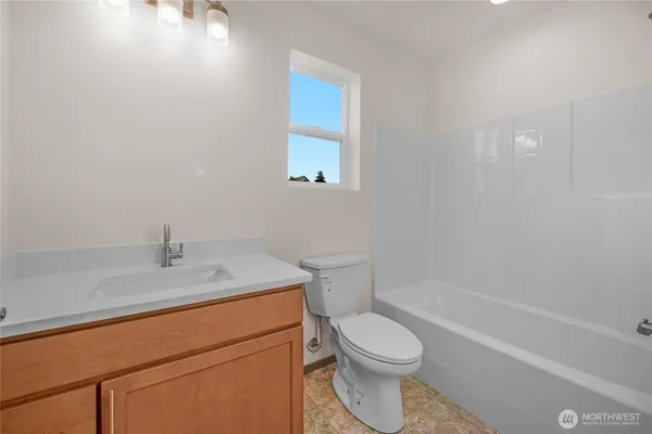 a bath room with a toilet a sink and a bath tub