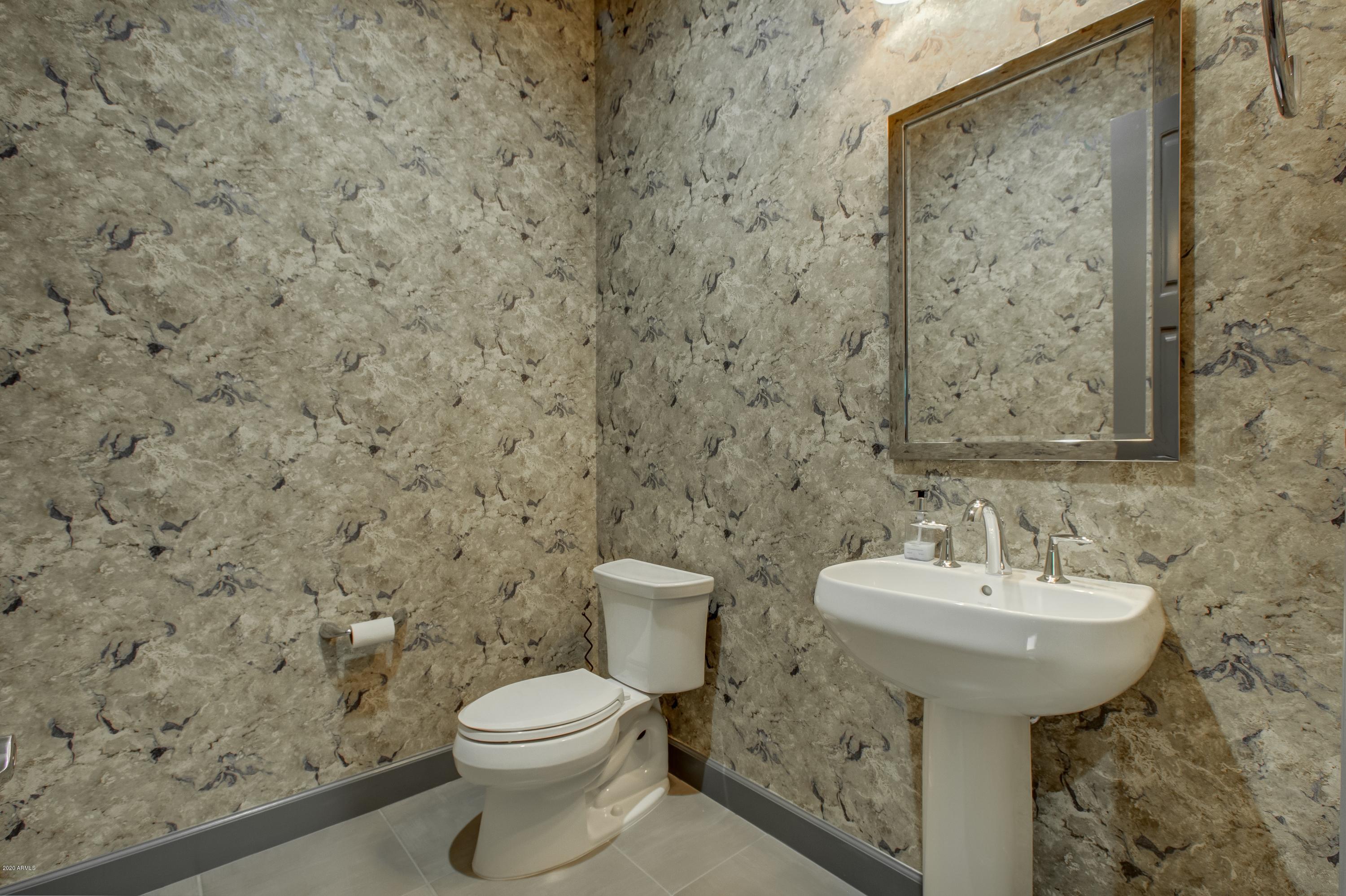 29324 North Round Butte Road Rio Verde, AZ 85263 - Photo 19 of 33 a bathroom with a sink a toilet and a mirror