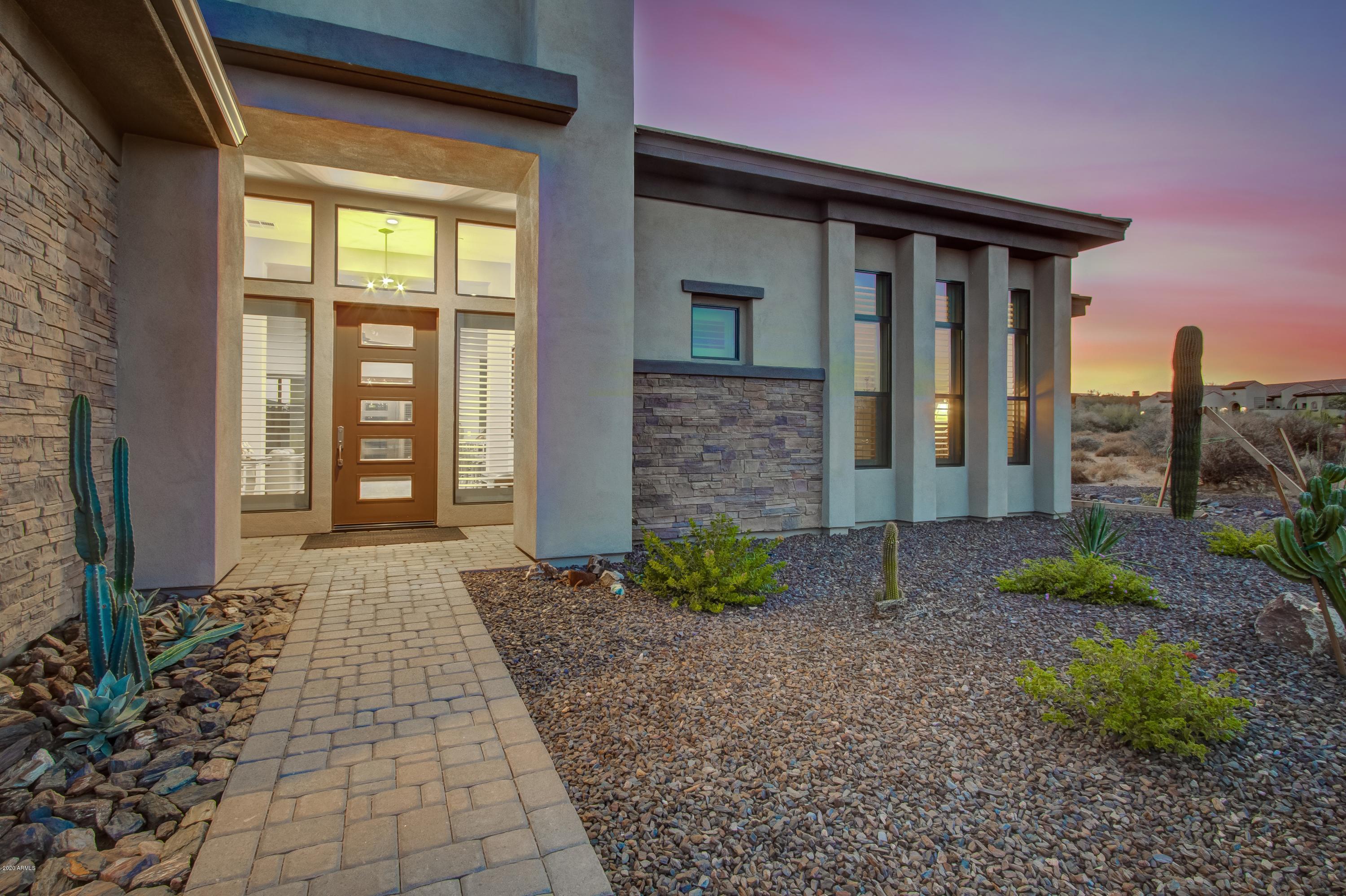 29324 North Round Butte Road Rio Verde, AZ 85263 - Photo 2 of 33 a front view of a house with garden