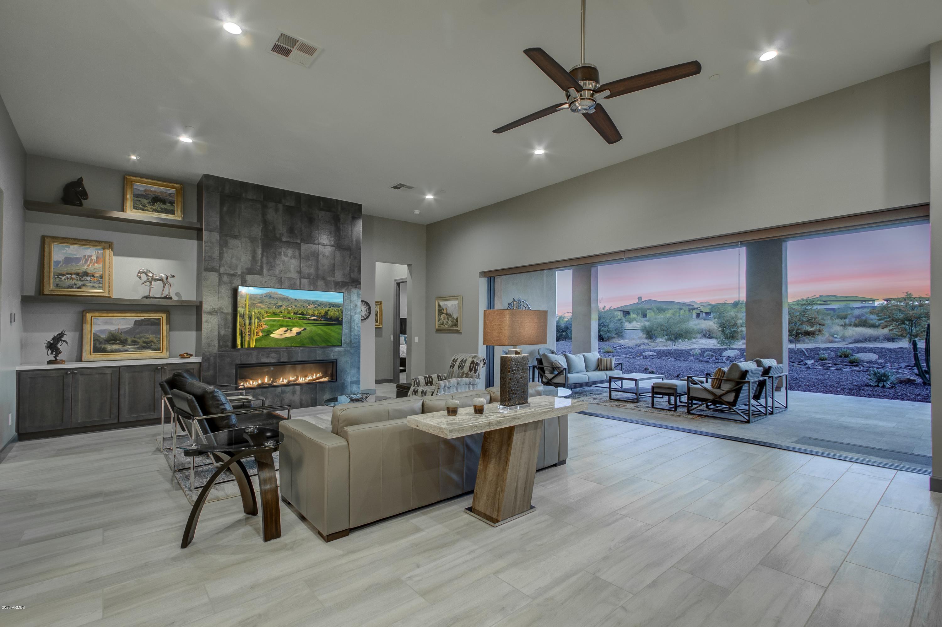 29324 North Round Butte Road Rio Verde, AZ 85263 - Photo 5 of 33 a living room with furniture a large window with kitchen view