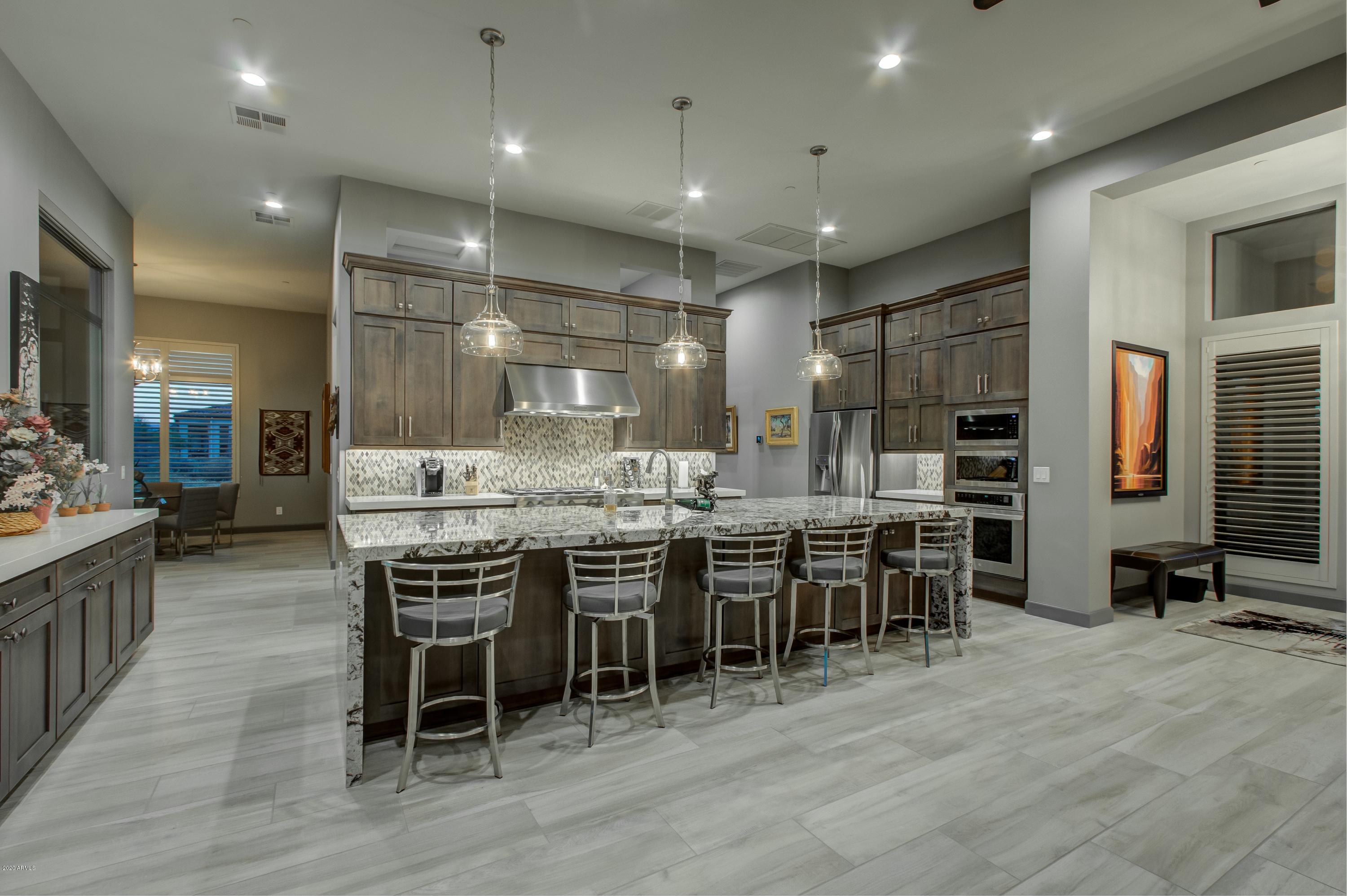 29324 North Round Butte Road Rio Verde, AZ 85263 - Photo 9 of 33 a kitchen with lots of counter space and dining table