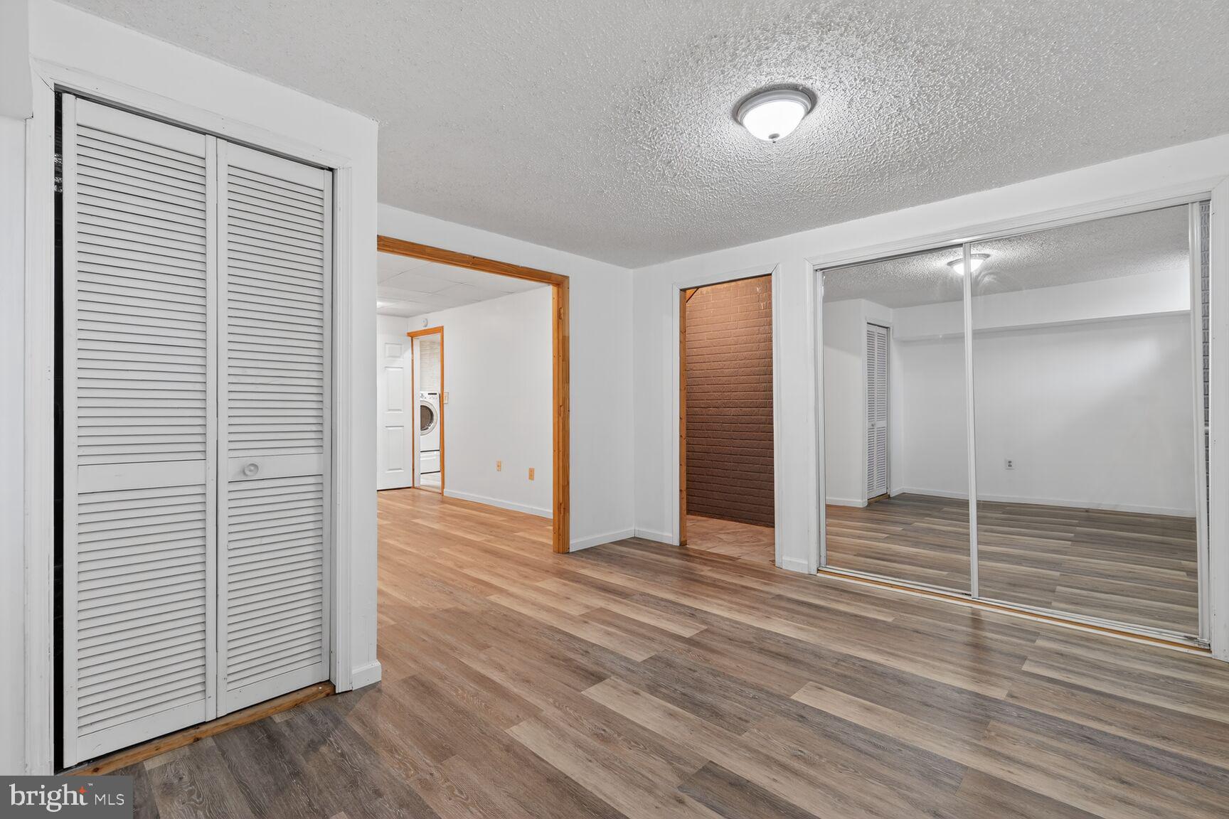 119 River Road Occoquan, VA 22125 - Photo 25 of 36 an empty room with wooden floor and windows