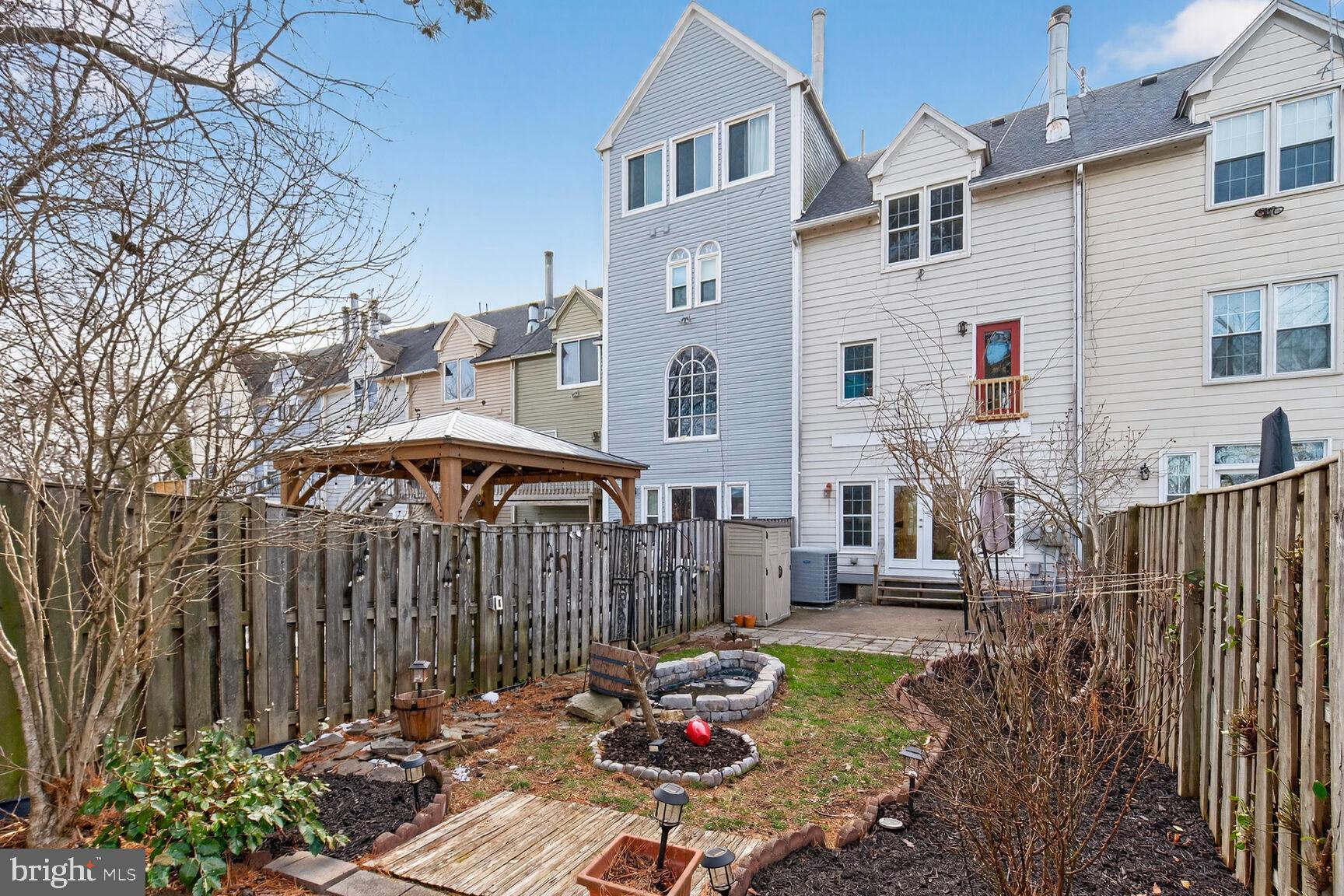 119 River Road Occoquan, VA 22125 - Photo 26 of 36 a backyard of a house with table and chairs under an umbrella