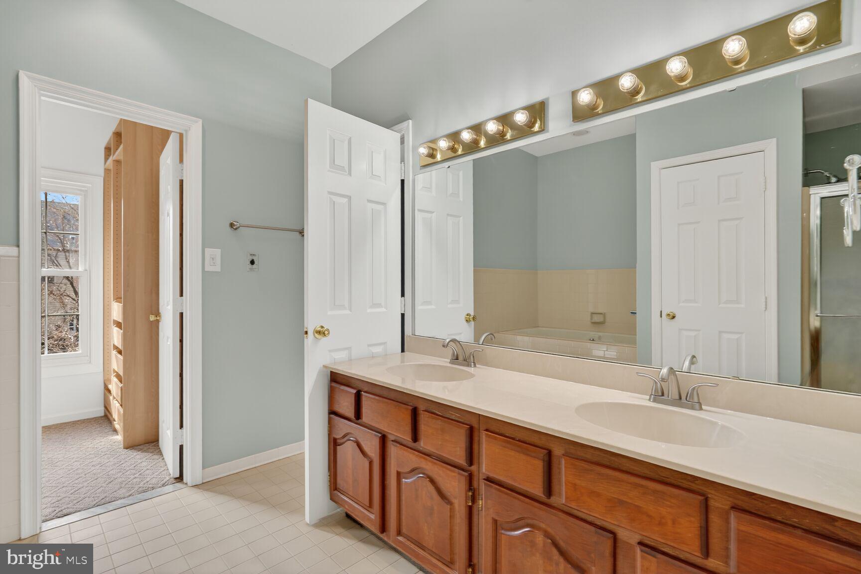 119 River Road Occoquan, VA 22125 - Photo 9 of 36 a spacious bathroom with a double vanity sink and a mirror