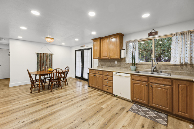 822 Pinewood Circle Price, UT 84501 - Photo 10 of 49 Open-concept kitchen and dining area featuring wood-finish flooring, recessed lighting, and a kitchen window overlooking mature trees