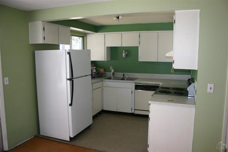 19129 Pumice Butte Road Bend, OR 97702 - Photo 5 of 18 a kitchen with a refrigerator sink and cabinets
