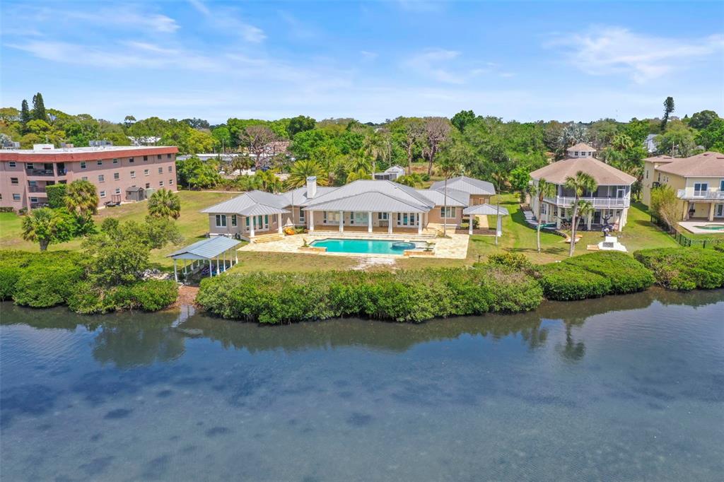 1721 Gulf Road Tarpon Springs, FL 34689 - Photo 1 of 96 an aerial view of a house with a garden and lake view
