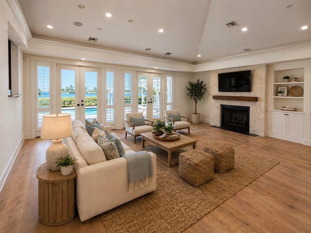 1721 Gulf Road Tarpon Springs, FL 34689 - Photo 17 of 96 a living room with furniture a flat screen tv and a fireplace