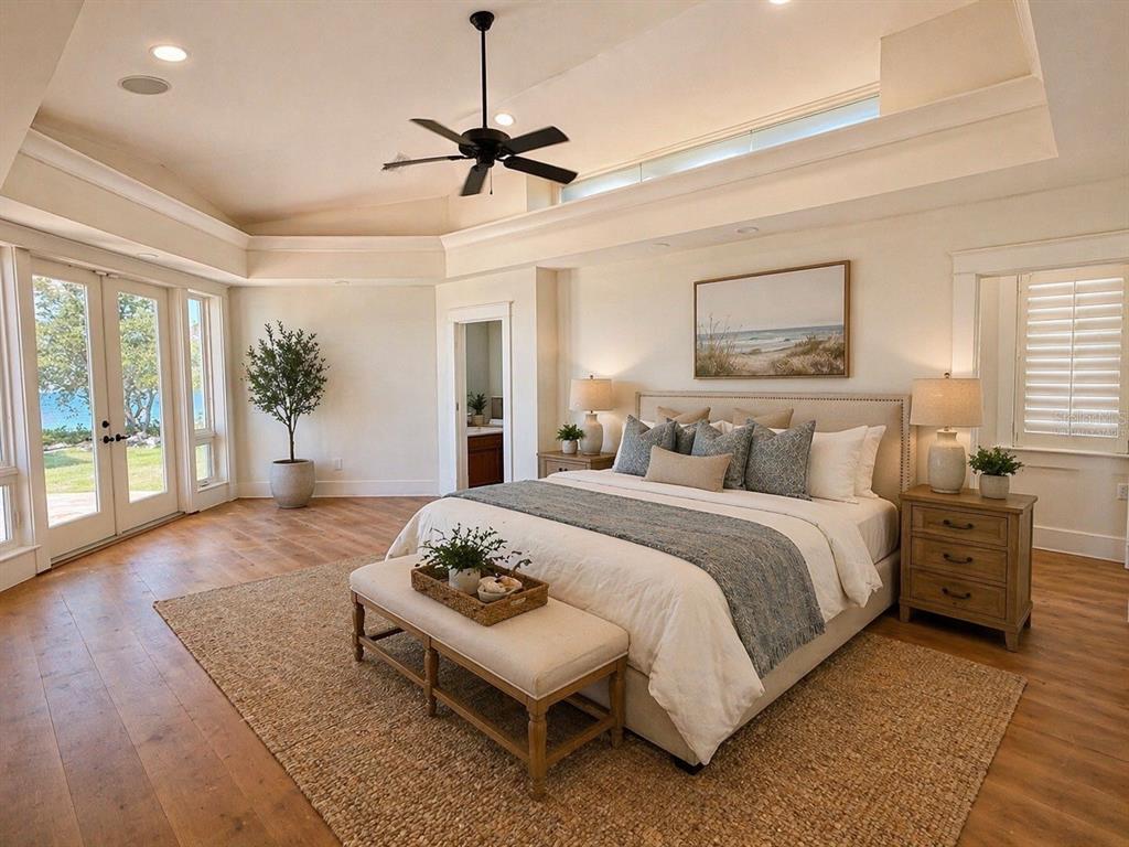 1721 Gulf Road Tarpon Springs, FL 34689 - Photo 24 of 96 a spacious bedroom with a bed a dresser and wooden floor