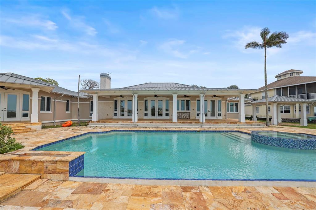 1721 Gulf Road Tarpon Springs, FL 34689 - Photo 49 of 96 a front view of a house with swimming pool having outdoor seating